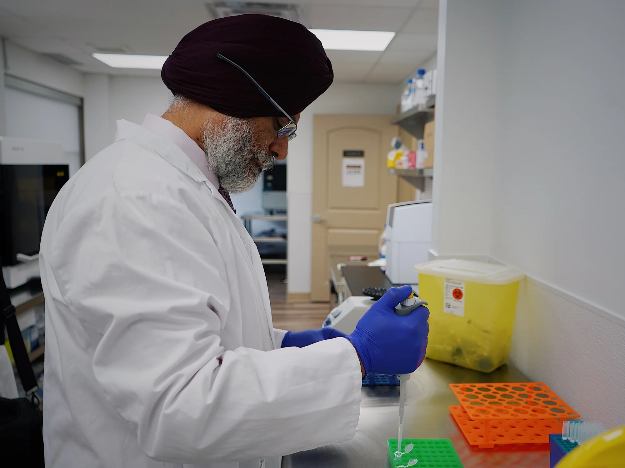 Laboratory technician pipetting samples in a hospital laboratory