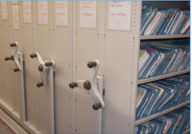 Rolling shelves of patient files in a medical records room