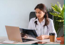 Doctor at the consultation desk reviewing a patient's X-ray